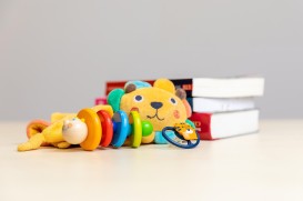 Children's toys in front of books.