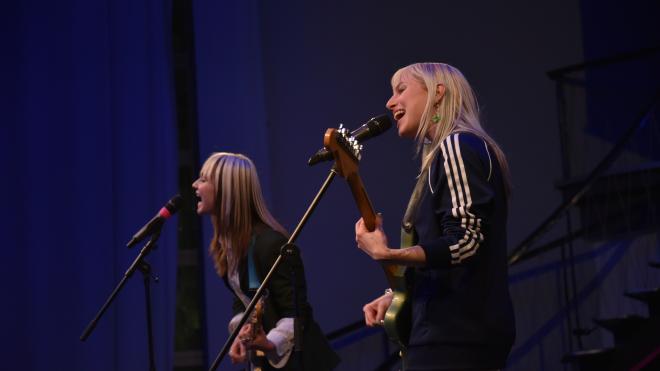 two people playing guitar