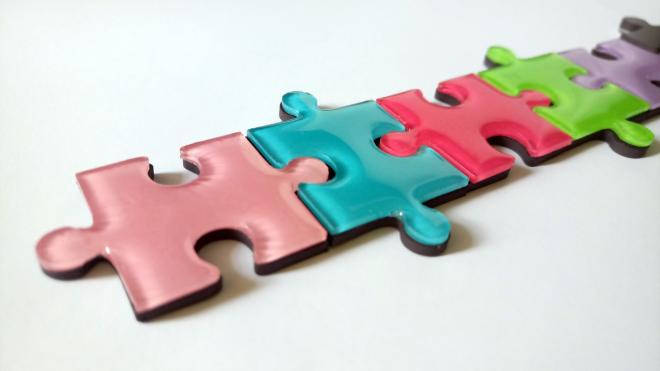 Four very large colorful puzzles pieces that are put together