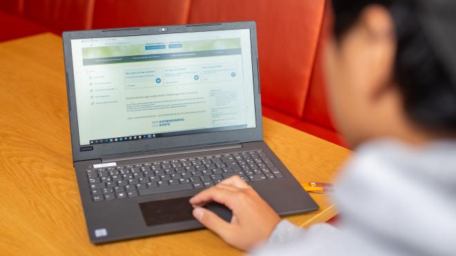 Person sitting in front of a laptop